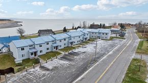 Kenai apartment for rent - A row of houses with a road in front of them.