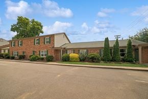 Charlotte apartment for rent - A building with a green lawn in front.