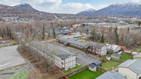 Eagle River apartment for rent - A parking lot with a mountain in the background.