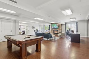 Bloomfield apartment for rent - A pool table is in the middle of a room with a fireplace.