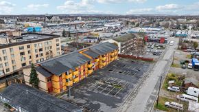 Anchorage apartment for rent - A parking lot in front of a multi-story building.