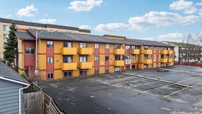 Anchorage apartment for rent - A parking lot in front of a row of apartment buildings.