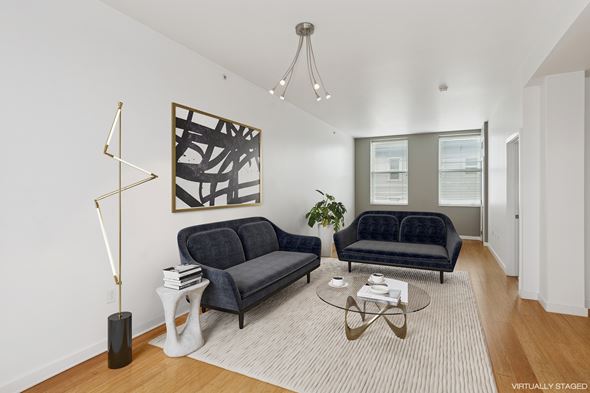 Pittsburgh apartment for rent - A living room with a black couch and a coffee table.