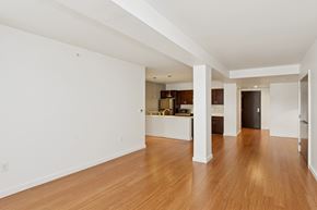 Pittsburgh apartment for rent - A spacious room with wooden floors and white walls.