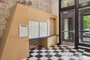 Minneapolis apartment for rent - a lockers area in front of a door with a black and white checkered floorat Gaar Scott Historic Lofts, Minneapolis, 55401