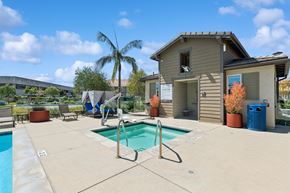 Goleta apartment for rent - A pool with a slide and a house in the background.