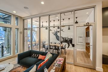 Portland apartment for rent - A living room with a black couch and a coffee table in front of a glass door.