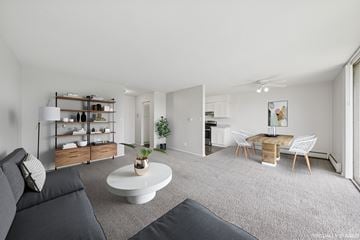 Naperville apartment for rent - A living room with a grey sofa and a white coffee table.