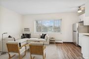 Minneapolis apartment for rent - A living room with a couch, chairs, and a window.