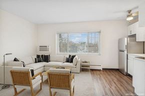 Minneapolis apartment for rent - A living room with a couch, chairs, and a window.