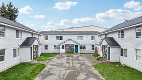 Anchorage apartment for rent - A courtyard surrounded by white houses.
