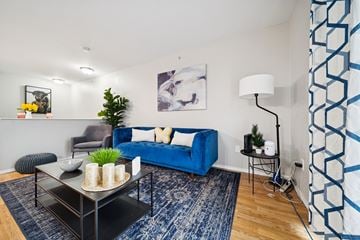 Anchorage apartment for rent - A living room with a blue couch and a black coffee table.