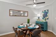 Burnsville apartment for rent - a dining room with a table and chairs and a ceiling fan