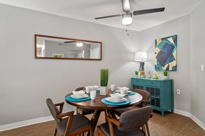 Burnsville apartment for rent - a dining room with a table and chairs and a ceiling fan
