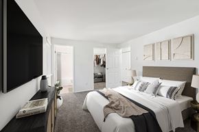 Beaverton apartment for rent - A bedroom with a large bed and a flat screen TV mounted on the wall.