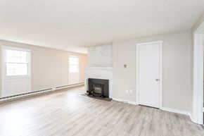 Ellington apartment for rent - an empty living room with a fireplace at Stonebridge, Connecticut