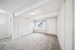 Anchorage apartment for rent - A spacious room with a carpeted floor and white walls.