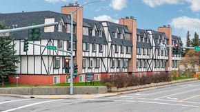 Anchorage apartment for rent - A street view of a building with a red brick chimney and a green traffic light.