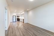 Paso Robles apartment for rent - A spacious room with wooden flooring and white walls.