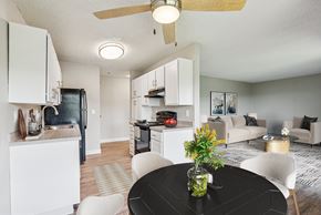 Milwaukie apartment for rent - A black table with a vase of flowers on it in a kitchen.