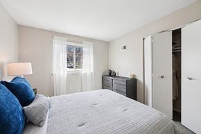 Odenton apartment for rent - A bedroom with a large bed and a window with curtains.