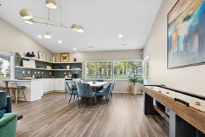 Wilsonville apartment for rent - A well-lit room with a pool table and a dining table with chairs.