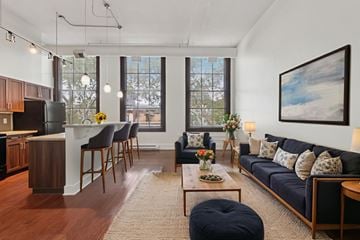 Pittsburgh apartment for rent - A living room with a black couch and a coffee table.