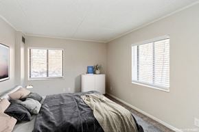Pittsburgh apartment for rent - A bedroom with a bed, a nightstand, and a window with blinds.