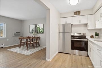 Minneapolis apartment for rent - A kitchen with a table and chairs in the middle of the room.