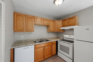 Winchester apartment for rent - a kitchen with white appliances and wooden cabinets