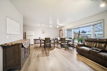 Soldotna apartment for rent - A living room with a brown leather couch and a wooden cabinet.