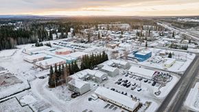 North Pole apartment for rent - A small town with buildings and cars is surrounded by snow.