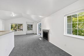 Beaverton apartment for rent - the living room and kitchen of a house with a fireplace