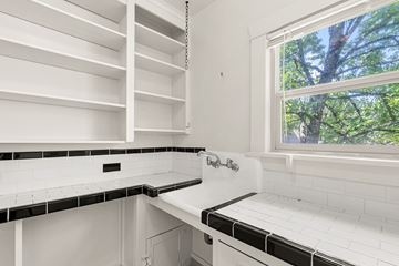 Portland apartment for rent - A white kitchen with black and white tiles.