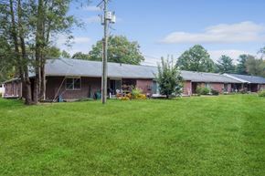 Ellington apartment for rent - a view of the front of a brick house with a green yard
