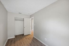 Winchester apartment for rent - a bedroom with hardwood floors and grey walls at Fort Collier Terrace, Winchester