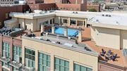 Wichita apartment for rent - A rooftop with a pool and loungers.