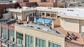 Wichita apartment for rent - A rooftop with a pool and loungers.
