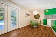 Riverside apartment for rent - a dining room with a table and chairs and a large window