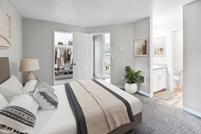Wilsonville apartment for rent - A bedroom with a large bed and a view of a hallway and closet.