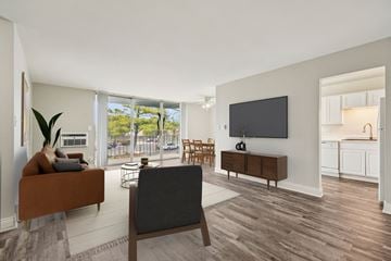 Naperville apartment for rent - A living room with a brown couch and a grey chair.