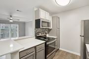 Sugar Hill apartment for rent - A kitchen with a white counter top and stainless steel appliances.