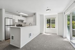 Beaverton apartment for rent - A kitchen with white cabinets and a stainless steel refrigerator.