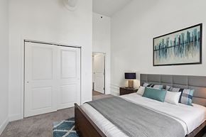 Pittsburgh apartment for rent - A bedroom with a bed, nightstand, and a painting on the wall.