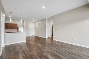 Pittsburgh apartment for rent - A spacious room with wooden flooring and white walls.