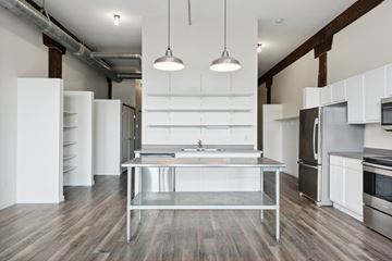 Minneapolis apartment for rent - a kitchen with white cabinets and stainless steel appliances