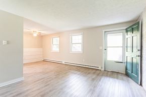 Ellington apartment for rent - living room with wood floors and a green door at Stonebridge, Connecticut, 06029