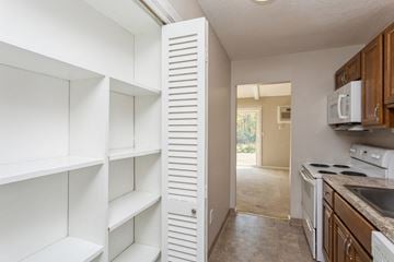 Ellington apartment for rent - a kitchen with white cabinets and a microwave and a sink