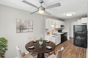 Aurora apartment for rent - A dining room with a table set for two and a ceiling fan.