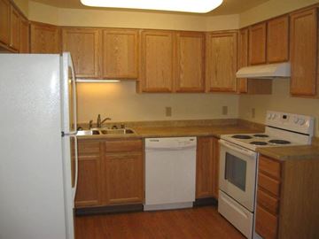 North Pole apartment for rent - a kitchen with white appliances and wooden cabinets